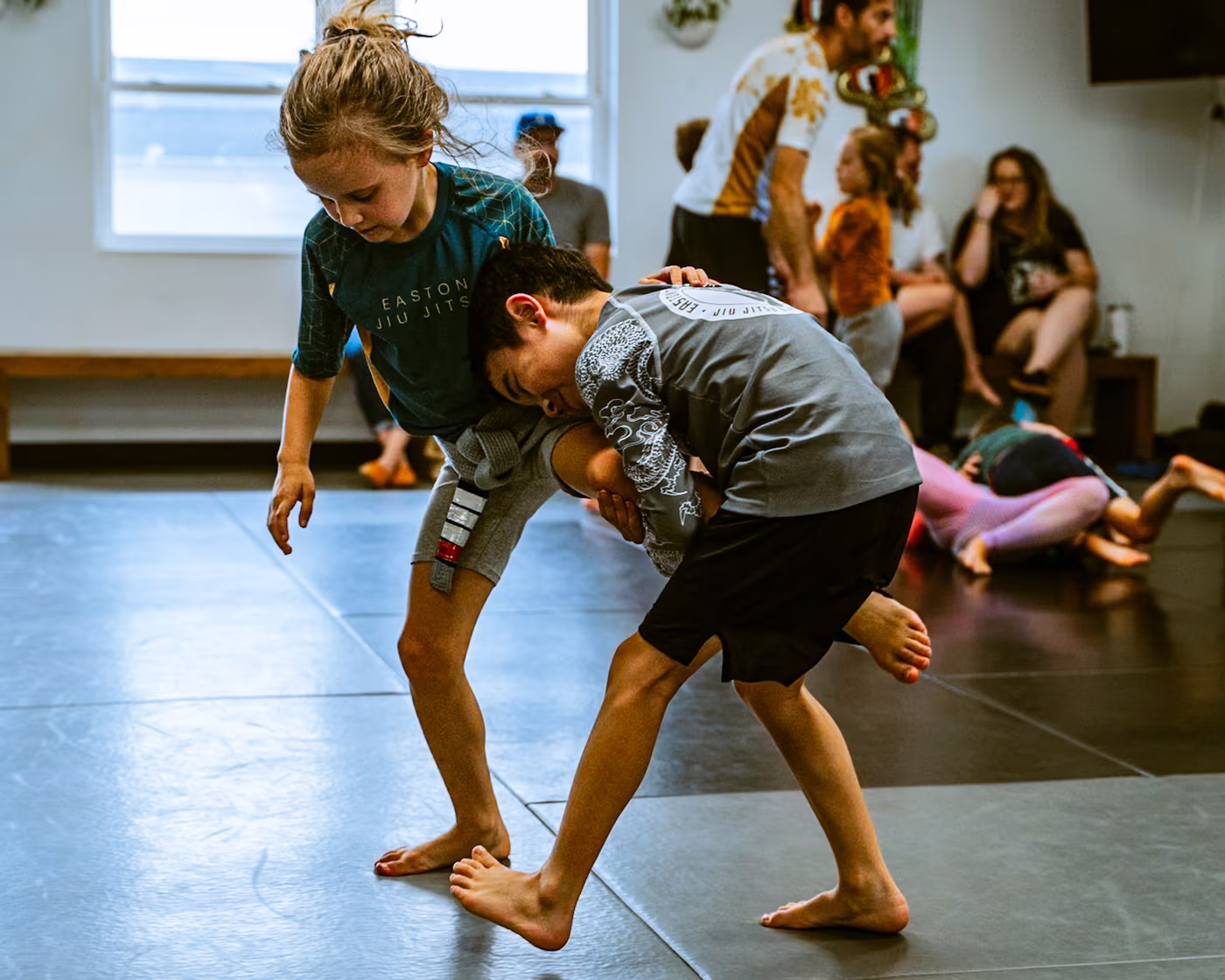 Two kids working takedowns and takedown defense in no-gi