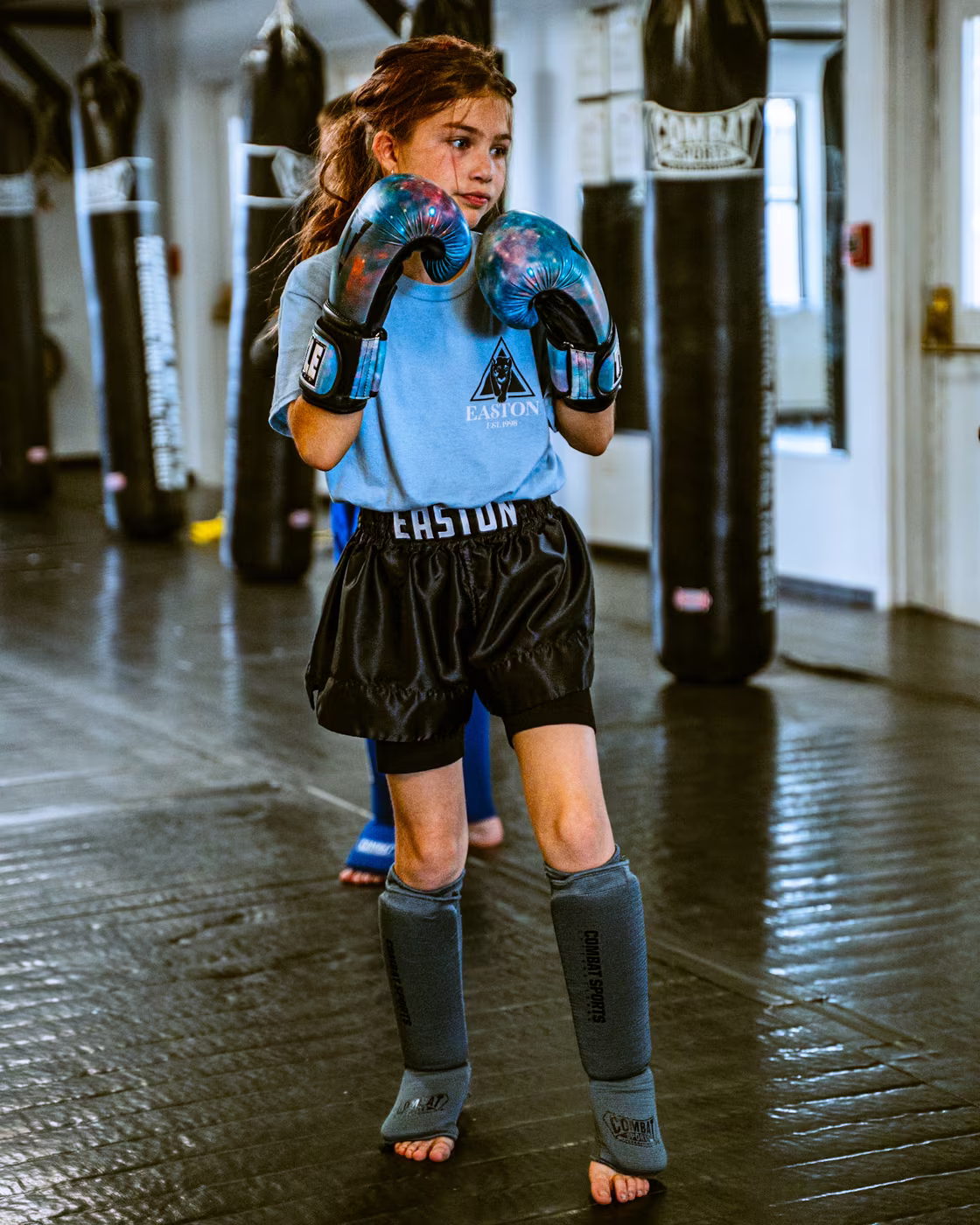 Girl in boxing gloves ready for her Kids Muay Thai class