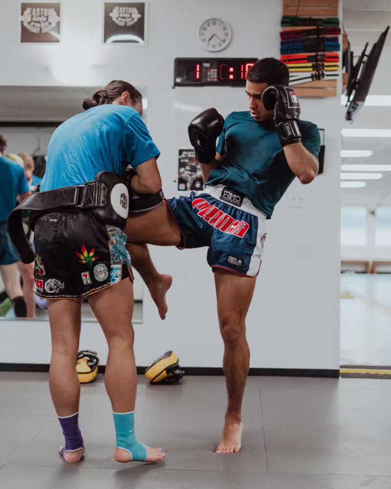 Knee strike on the pads at Easton Littleton Muay Thai