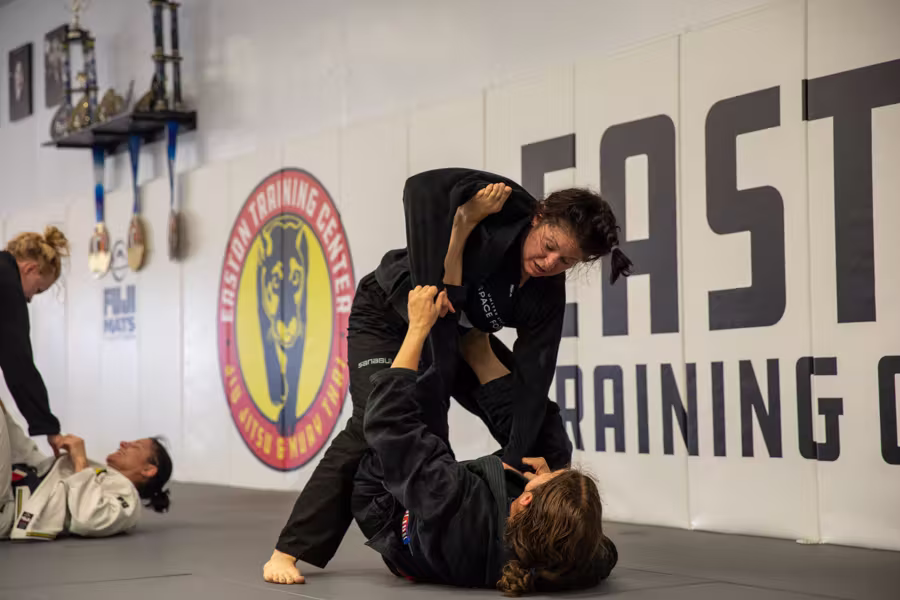 Live rounds on the mat under the Easton Training Center wall graphic