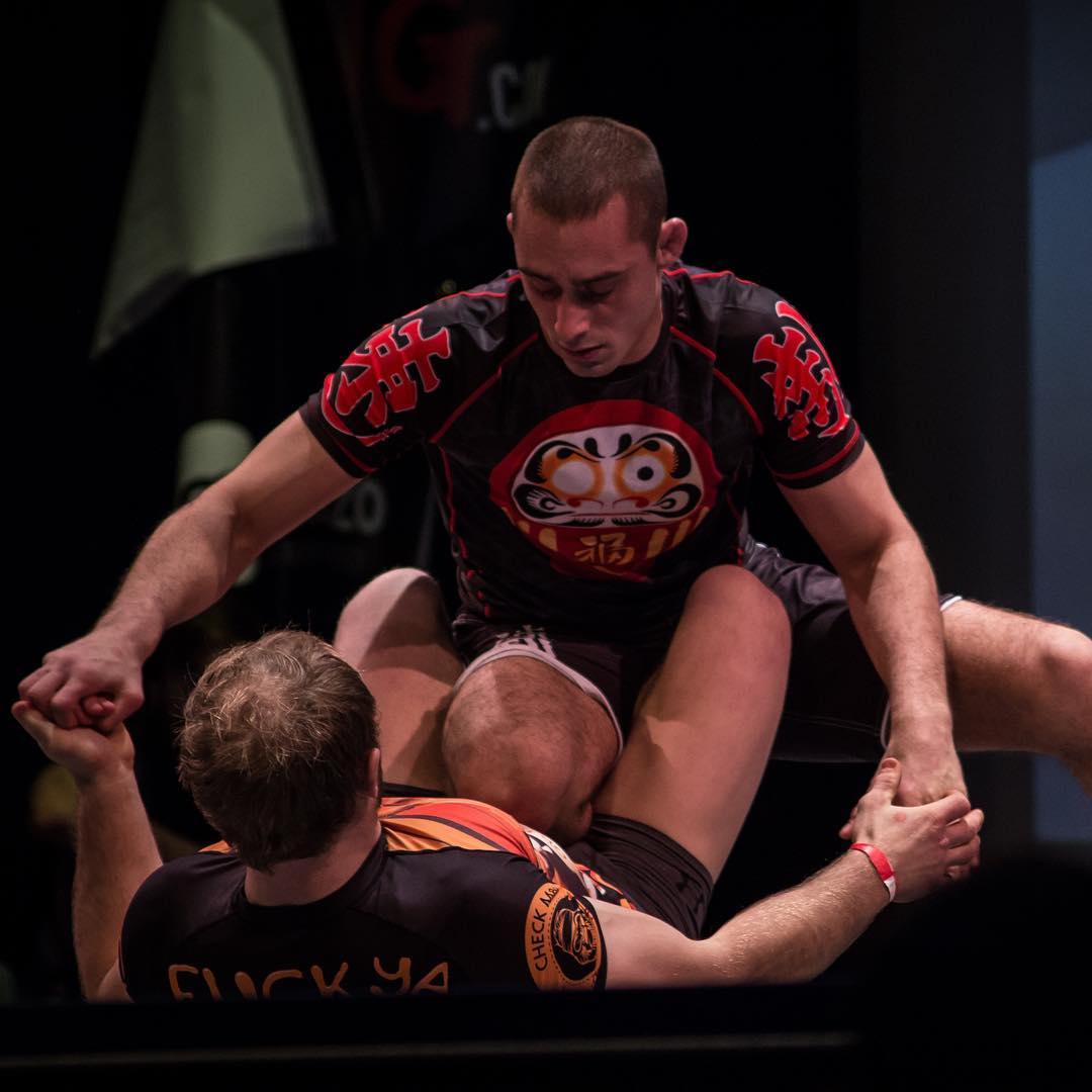 Jason Rau in the top of open guard in no-gi BJJ competition