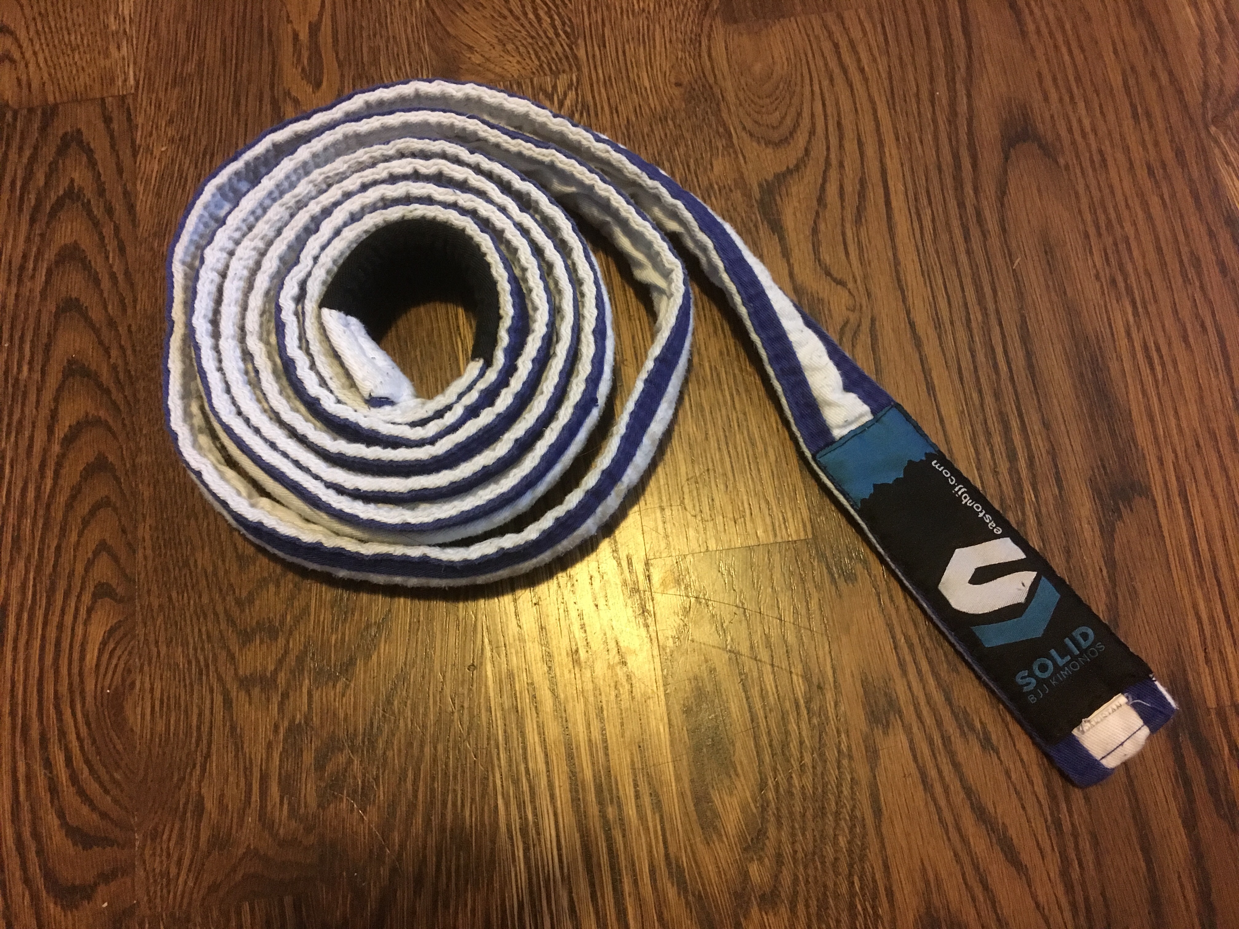A white belt with two stripes.