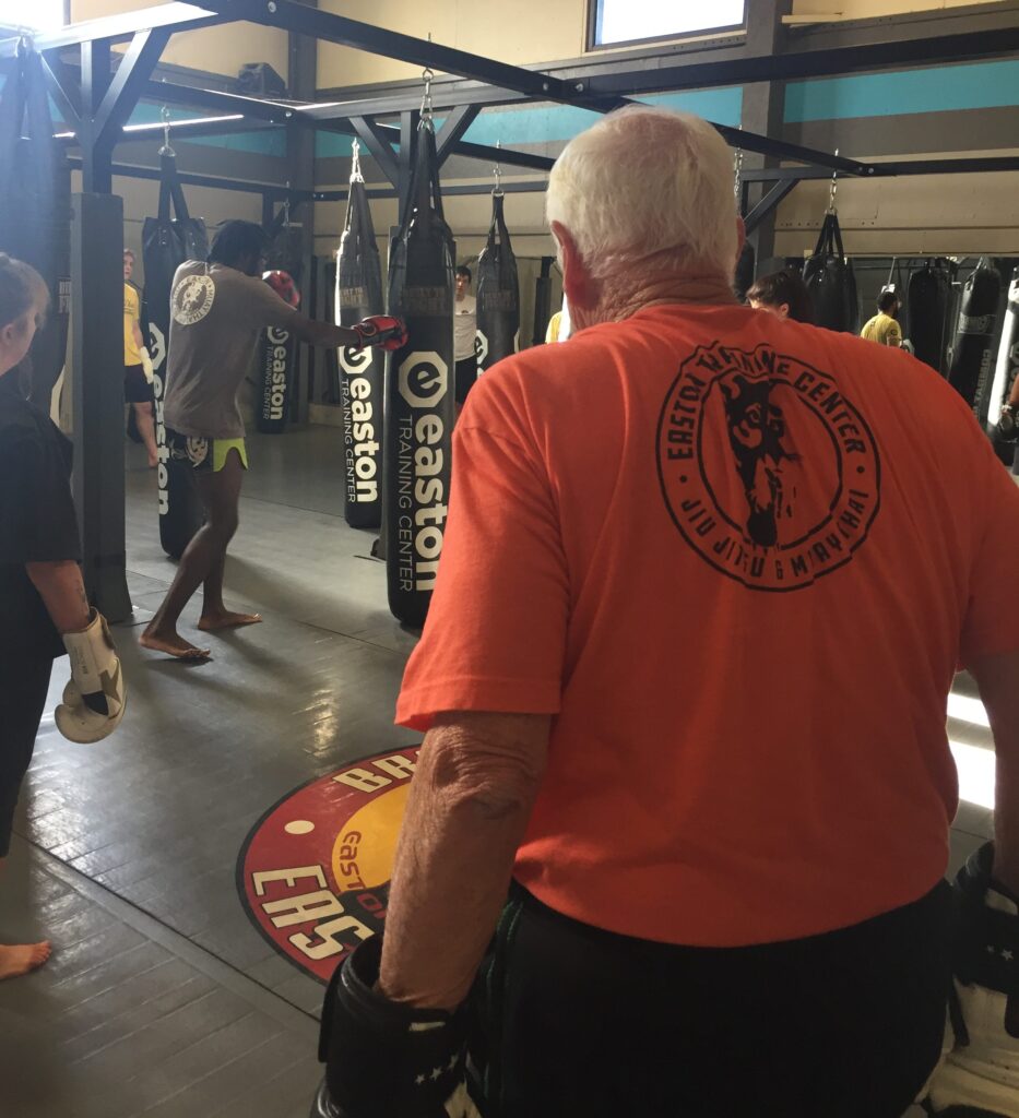 A student observes a kickboxing instructor demonstrating a punching technique at Easton Training Center.