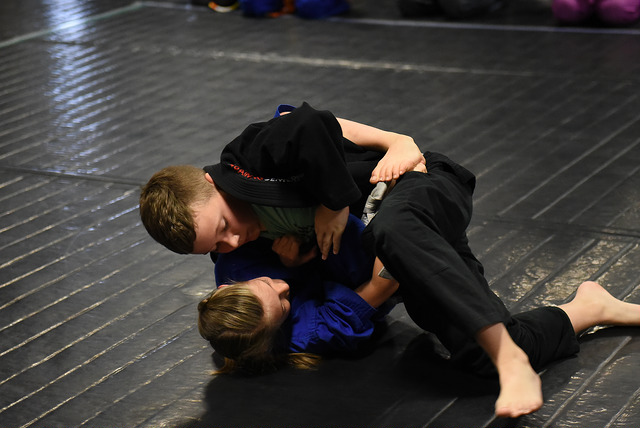 A boy and a girl grapple in a Jiu Jitsu match at Easton Training Center