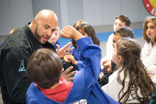 Eliot Marshall talks with kids during martial arts class