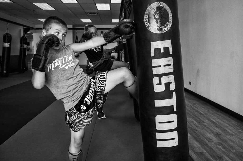 An image of a kid practicing Muay Thai at our martial arts academy in Colorado.