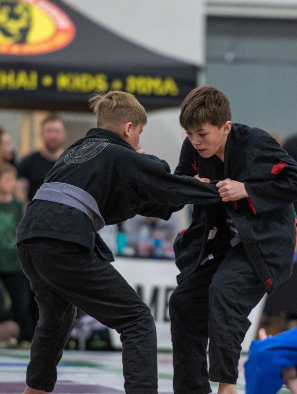 Two kids competing at a jiu jitsu tournament in Colorado.