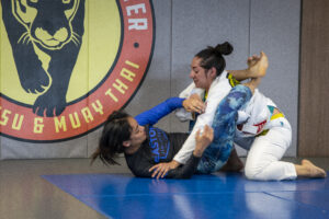 two women training Brazilian Jiu Jitsu closed guard