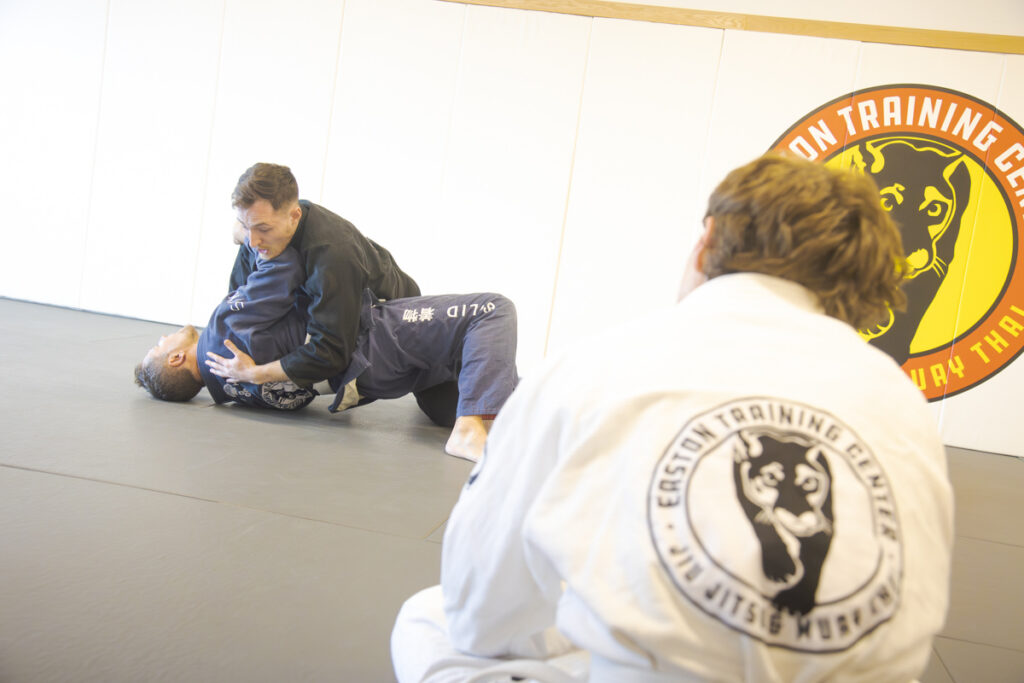 Two men practice side control Jiu Jitsu drills