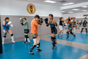 several pairs of women in a Muay Thai sparring session 