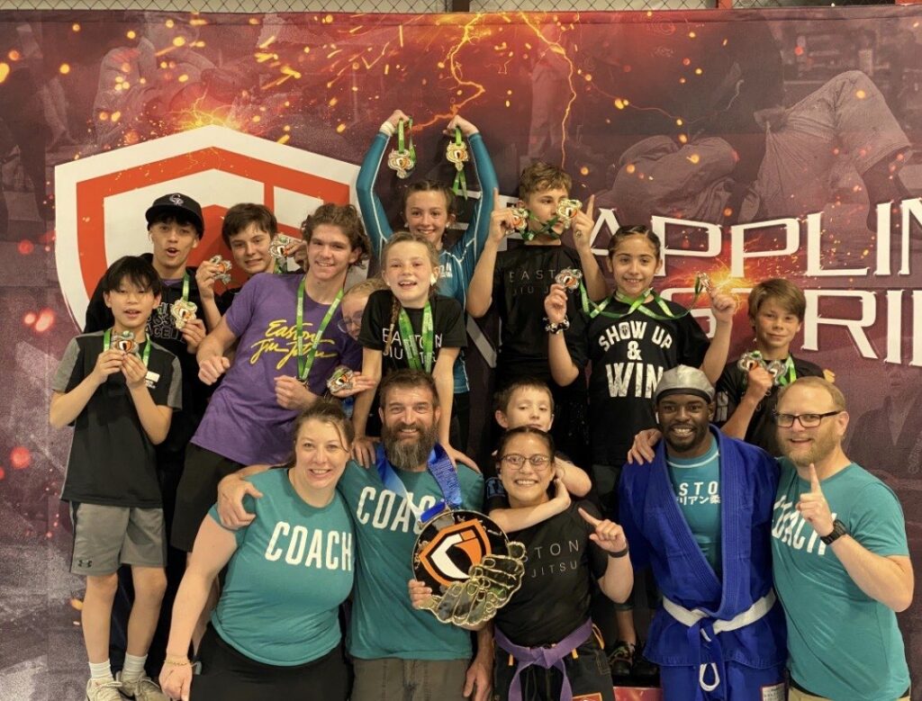 a group of kids BJJ competitors and coaches at a Grappling Industries tournament