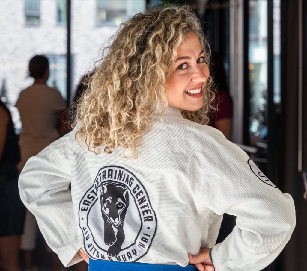 Marta Spirk in a white gi looking over her shoulder