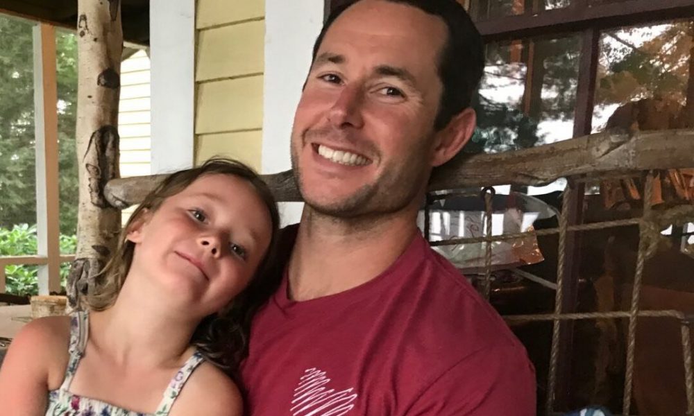 PT Matt Smith sits with his daughter in his lap